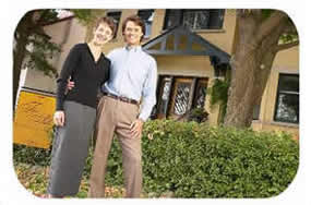 Couple in front of house